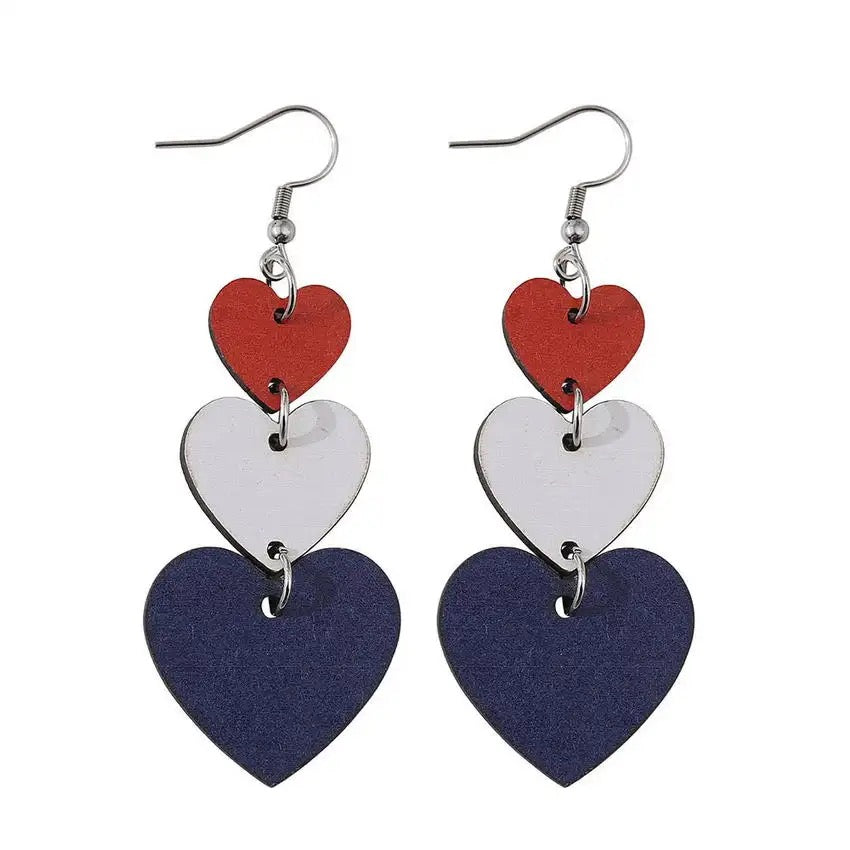 Wood and metal dangle earrings featuring three stacked hearts in red white and blue with silver hooks
