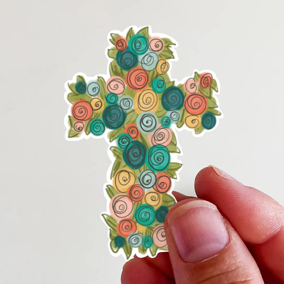 Digital illustration sticker of a cross formed by vibrant swirl-patterned flowers in teal, orange, pink, and yellow hues with green leaves, held by fingers against a plain white background