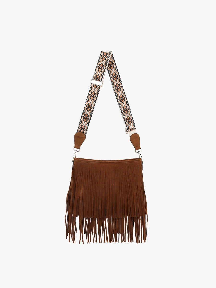 Brown suede fringe handbag with an adjustable wide strap featuring a colorful geometric pattern in black, white, and tan