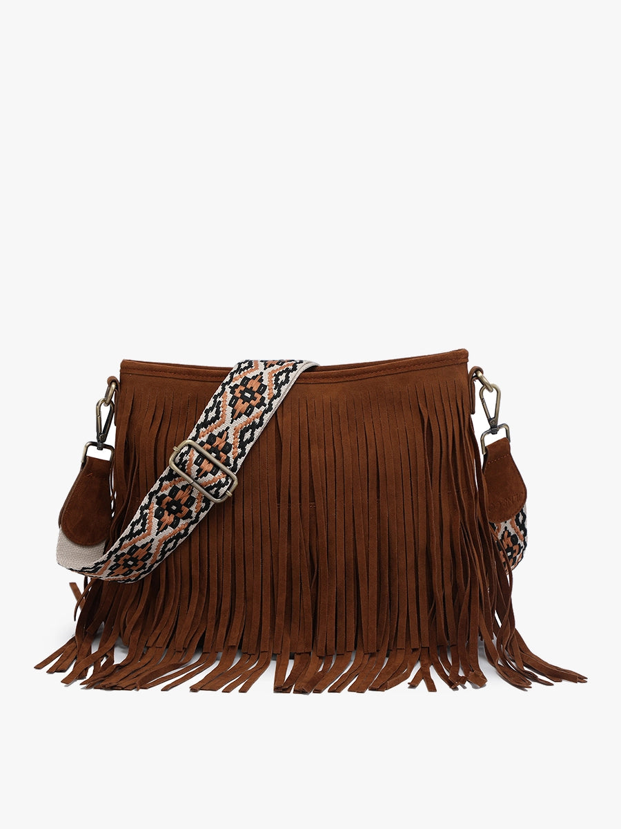Product photograph of a brown suede fringed crossbody bag with a wide adjustable shoulder strap featuring a geometric pattern in black, orange, and cream on a white background