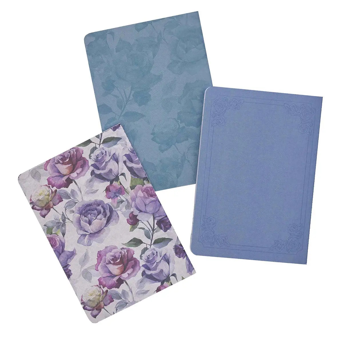 Three decorative notebooks displayed on a white background featuring a purple and white watercolor floral pattern, a light blue notebook with an embossed rose border, and a teal notebook with a subtle rose motif